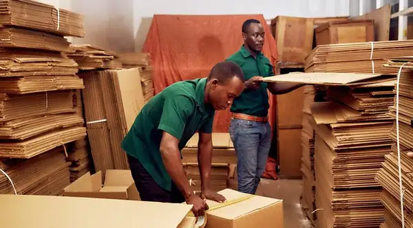 DOKI Movers team packing boxes in warehouse